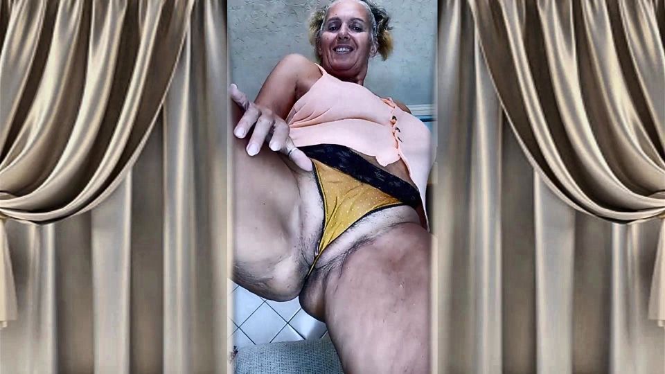 Cheerful old lady Lukerya. Alluring movements and shiny feet on the washing machine.