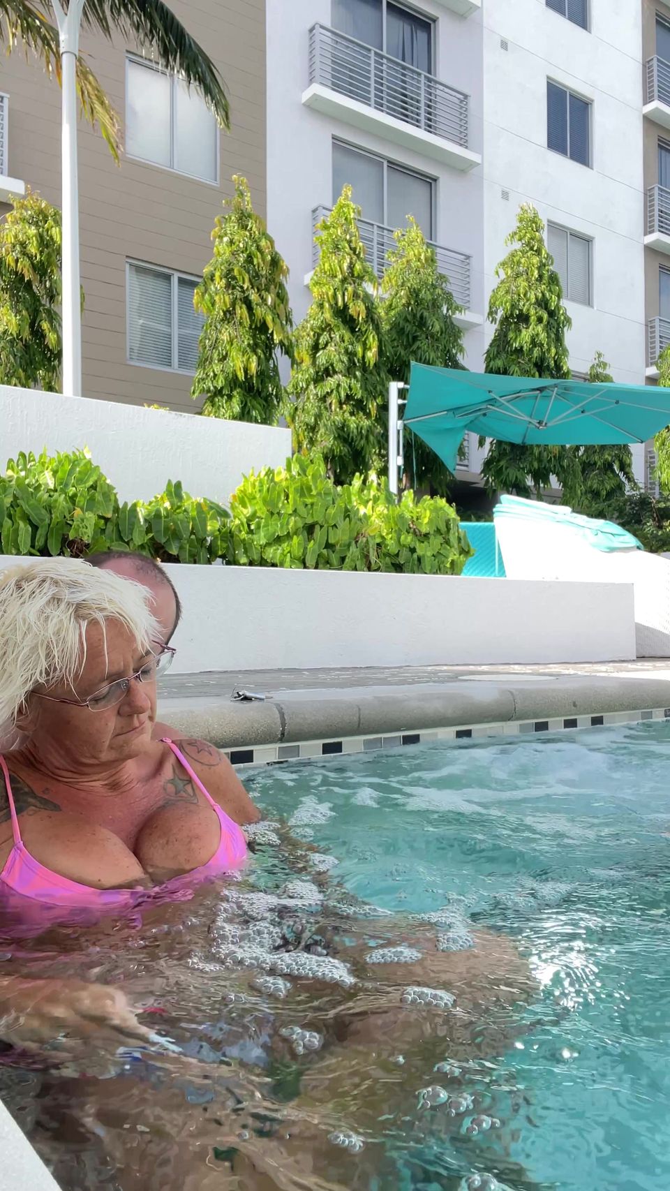 Getting frisky in the hot tub. Boob play.