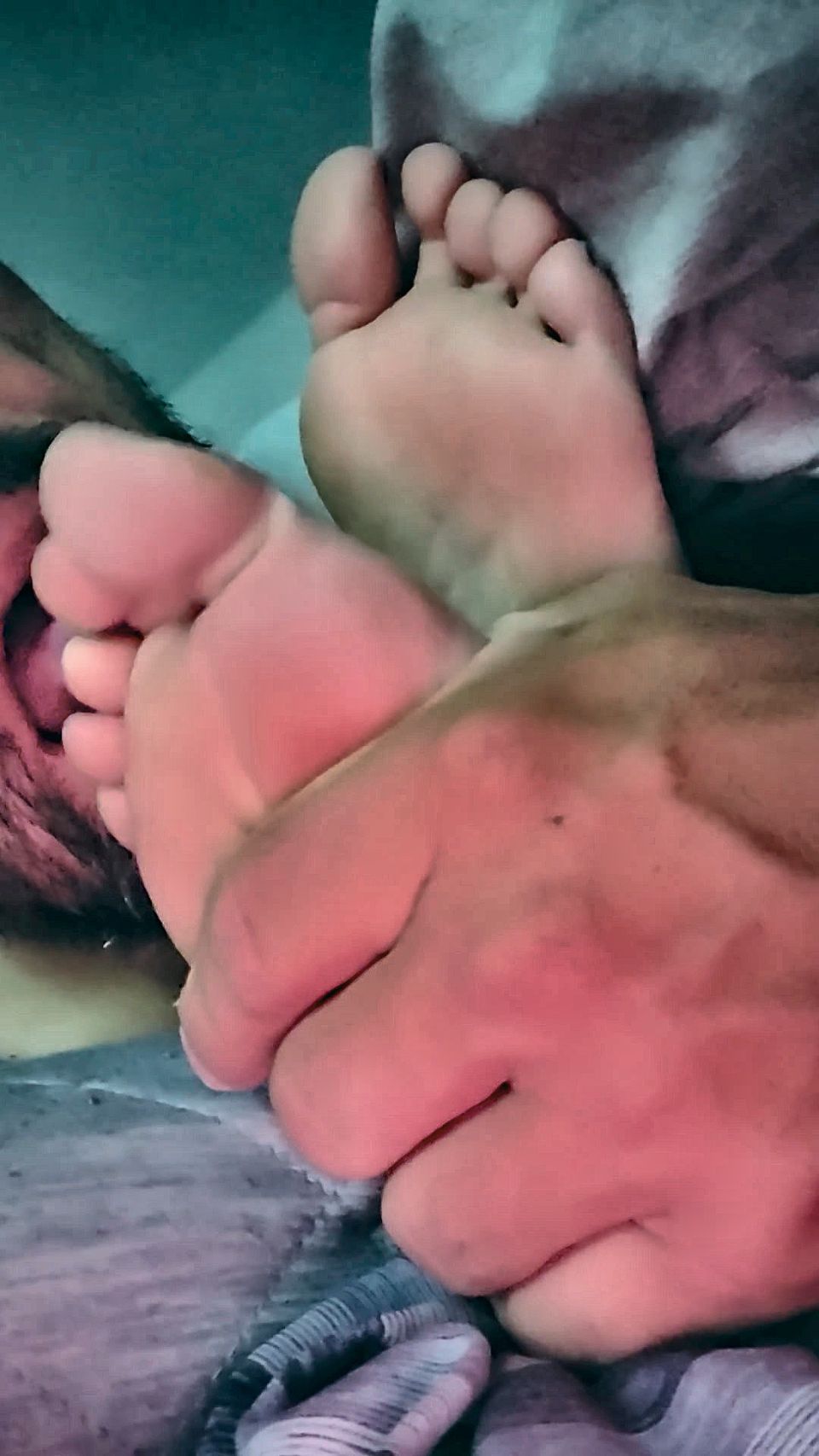 Sucking her toes while she watches a movie
