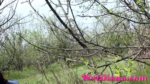 Pissing in the grass with legs wide opened and wipe her pussy with a leaf