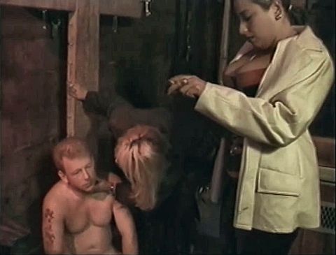 Bound man is subdued with strange penis remedy by two chicks in dungeon