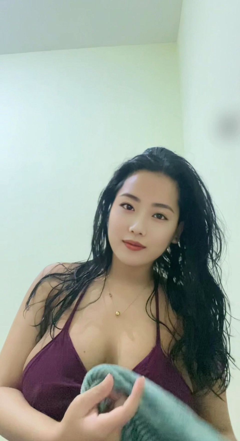 A young mother with big breasts, wearing a sexy outfit after a shower looking incredibly alluring.