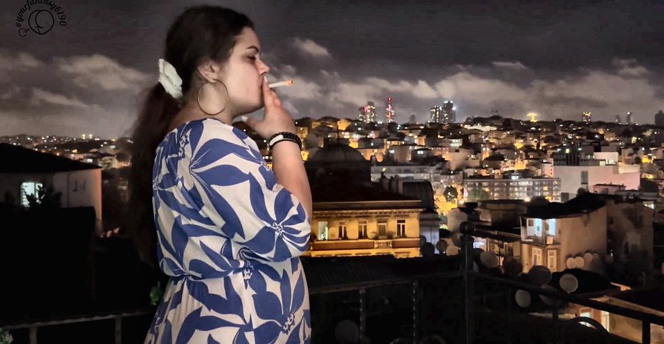 Smoking on the Balcony with a City View
